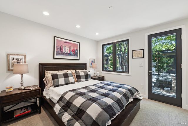 a view of a swimming pool with a table and chairs under an umbrella
