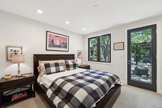 a view of a swimming pool with a table and chairs under an umbrella