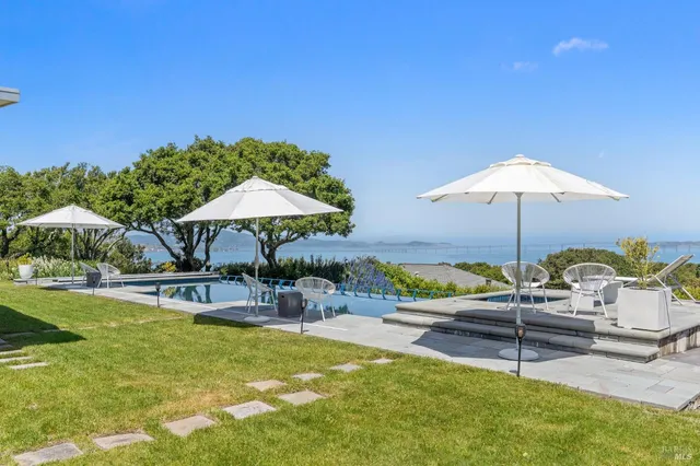 a view of a house with a yard and sitting area