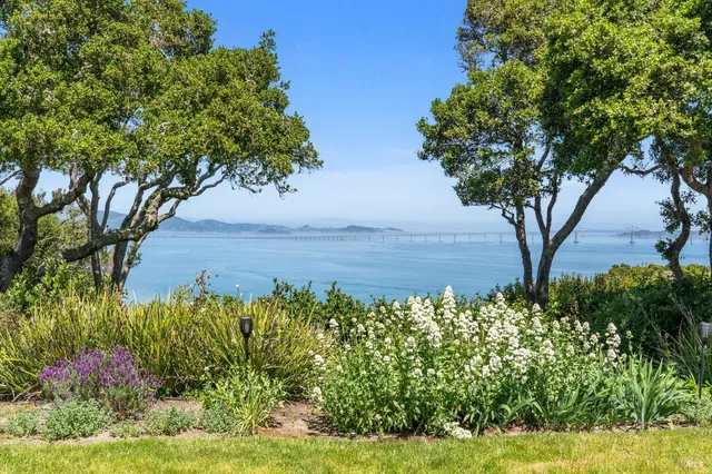 a view of a house with backyard water fountain and sitting area