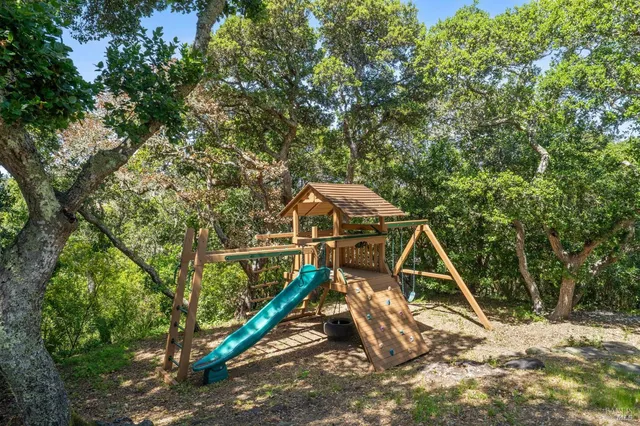 a backyard of a house with table and chairs