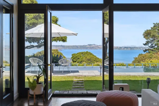 a living room filled with furniture and a large window