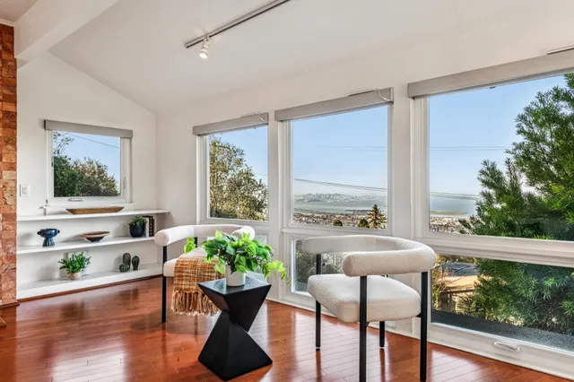 a vase of flowers sitting on a table with a potted plant