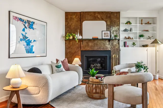 a living room with furniture and a fireplace