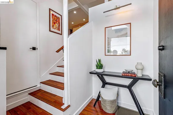 a bedroom with a bed and a lamp on dresser