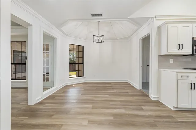 an aerial view of a house with a yard and garden