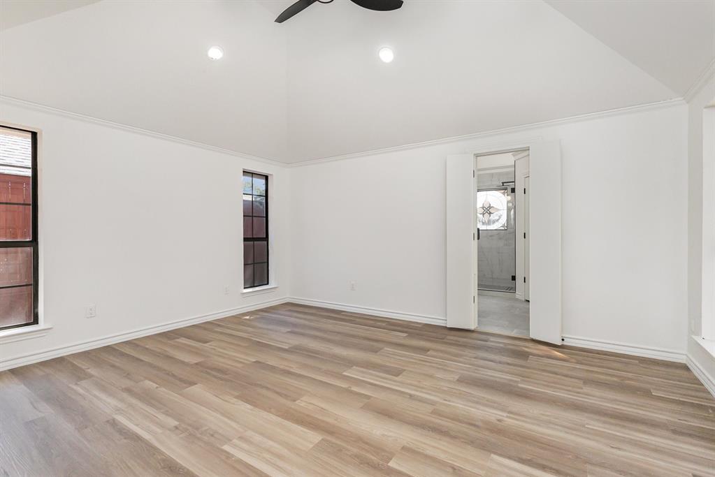 922 Sycamore Creek Road Allen, TX 75002 - Photo 22 of 38 Unfurnished room featuring light wood-type flooring, high vaulted ceiling, recessed lighting, ceiling fan, and crown molding