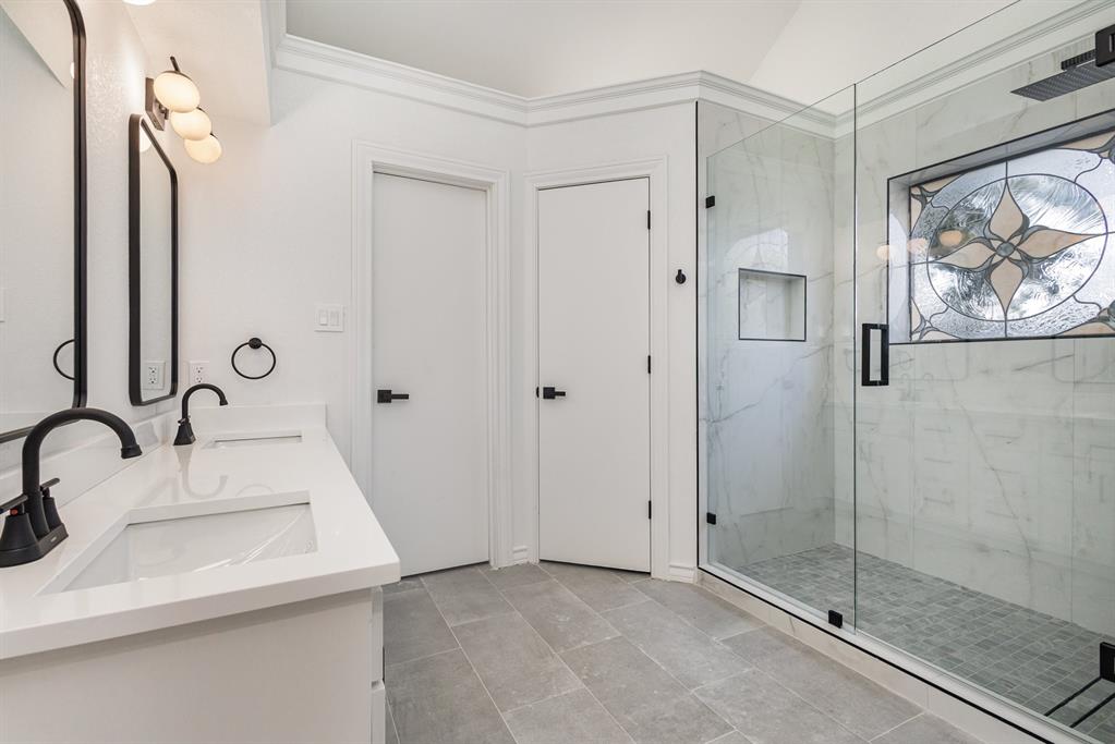 922 Sycamore Creek Road Allen, TX 75002 - Photo 23 of 38 Full bath featuring a marble finish shower, ornamental molding, double vanity, and light tile patterned floors