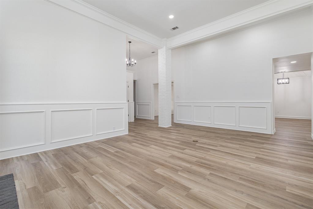 922 Sycamore Creek Road Allen, TX 75002 - Photo 24 of 38 Spare room with a chandelier, light wood-style flooring, ornamental molding, recessed lighting, and a decorative wall
