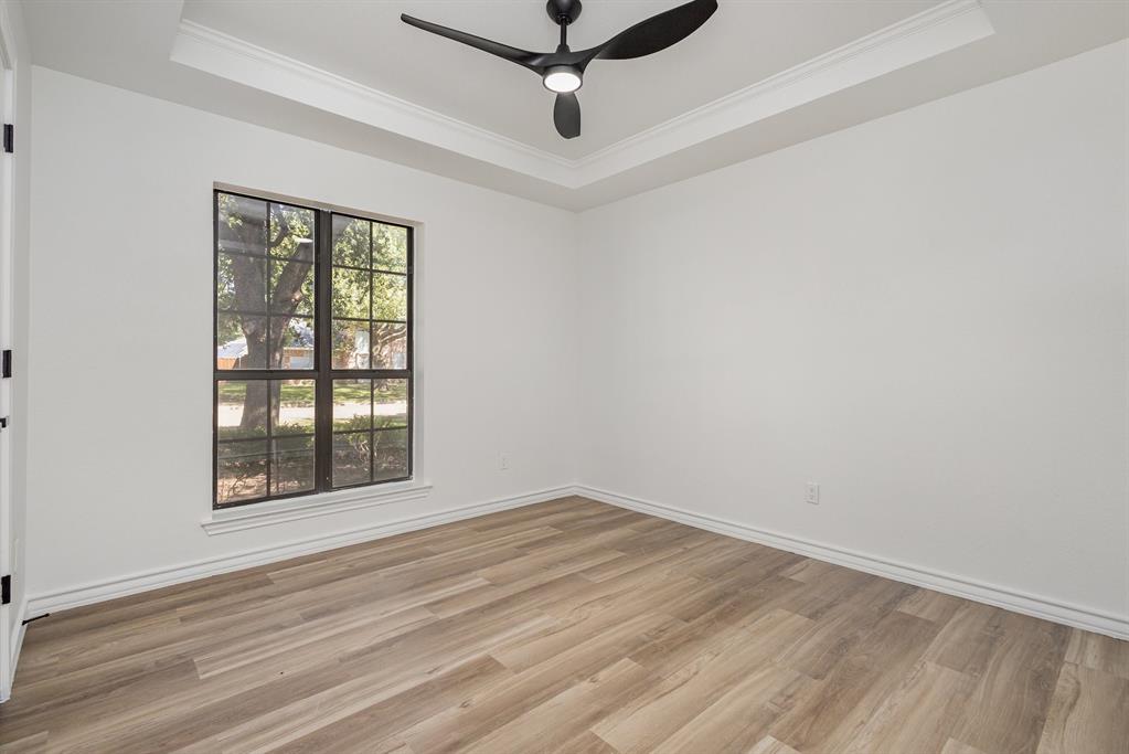 922 Sycamore Creek Road Allen, TX 75002 - Photo 25 of 38 Spare room featuring a tray ceiling, wood finished floors, crown molding, and a ceiling fan