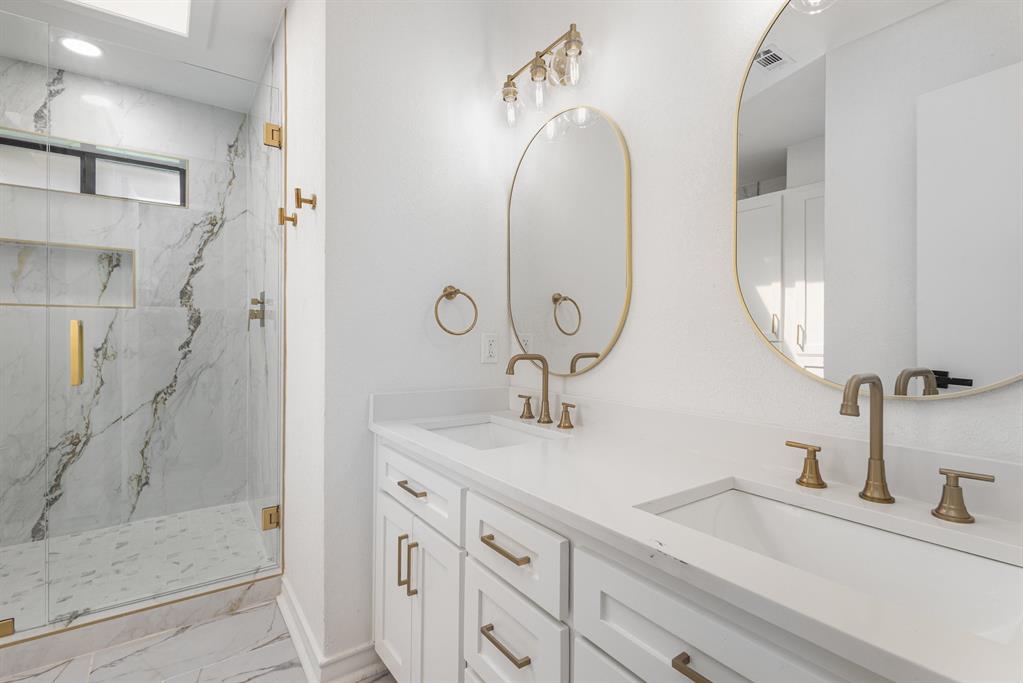 922 Sycamore Creek Road Allen, TX 75002 - Photo 3 of 38 Bathroom featuring light marble finish flooring, double vanity, and a marble finish shower