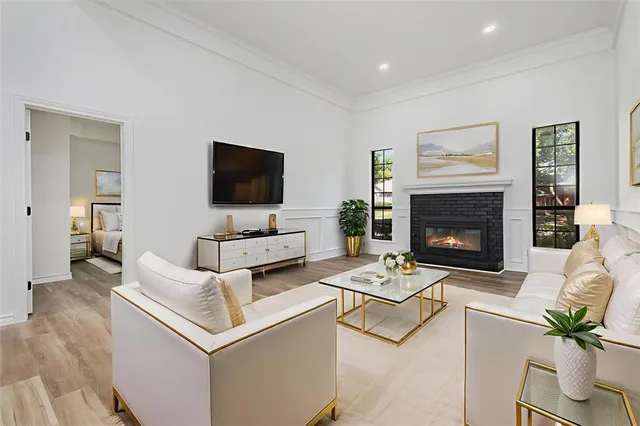 a dining room with furniture a chandelier and wooden floor