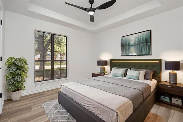 an empty room with wooden floor fireplace and windows