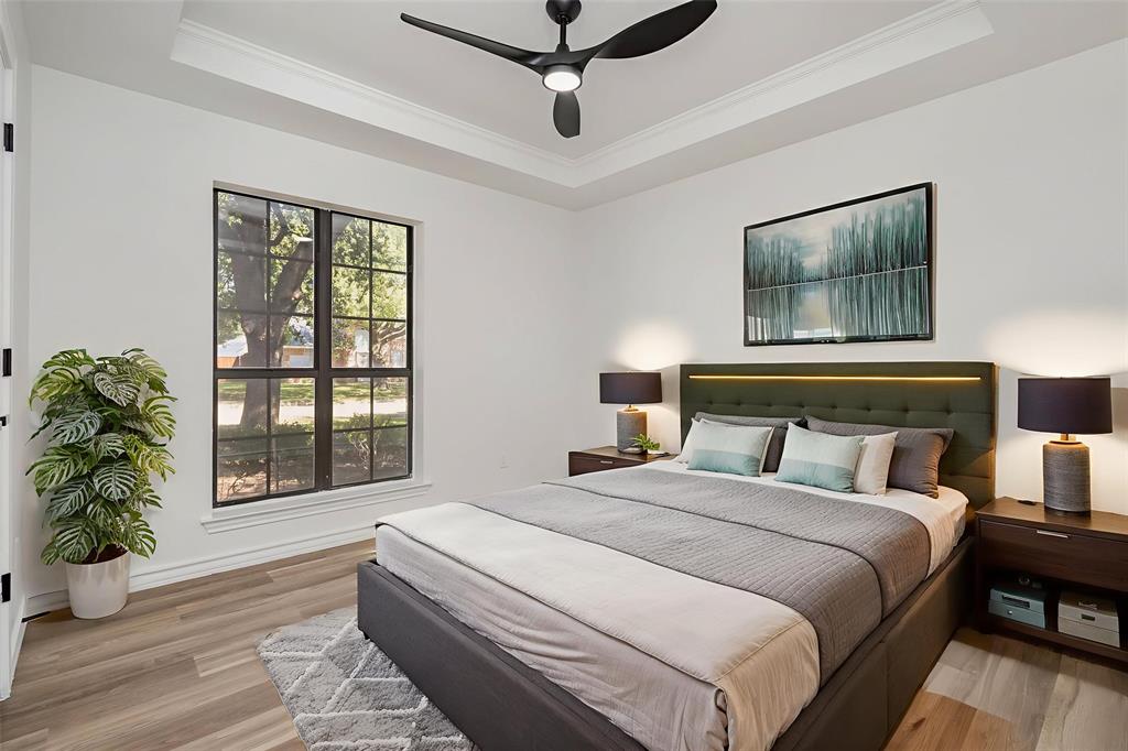 922 Sycamore Creek Road Allen, TX 75002 - Photo 9 of 38 Bedroom with a tray ceiling, light wood-style floors, ornamental molding, and ceiling fan