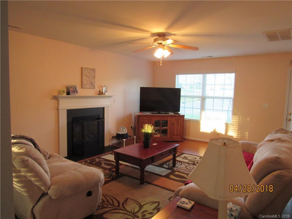 7606 West Berkeley Road Denver, NC 28037 - Photo 3 of 22 a living room with furniture and a fireplace