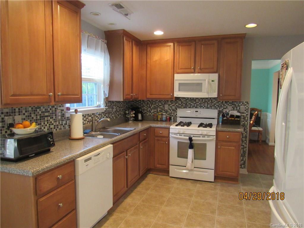 7606 West Berkeley Road Denver, NC 28037 - Photo 4 of 22 a kitchen with a stove sink and cabinets