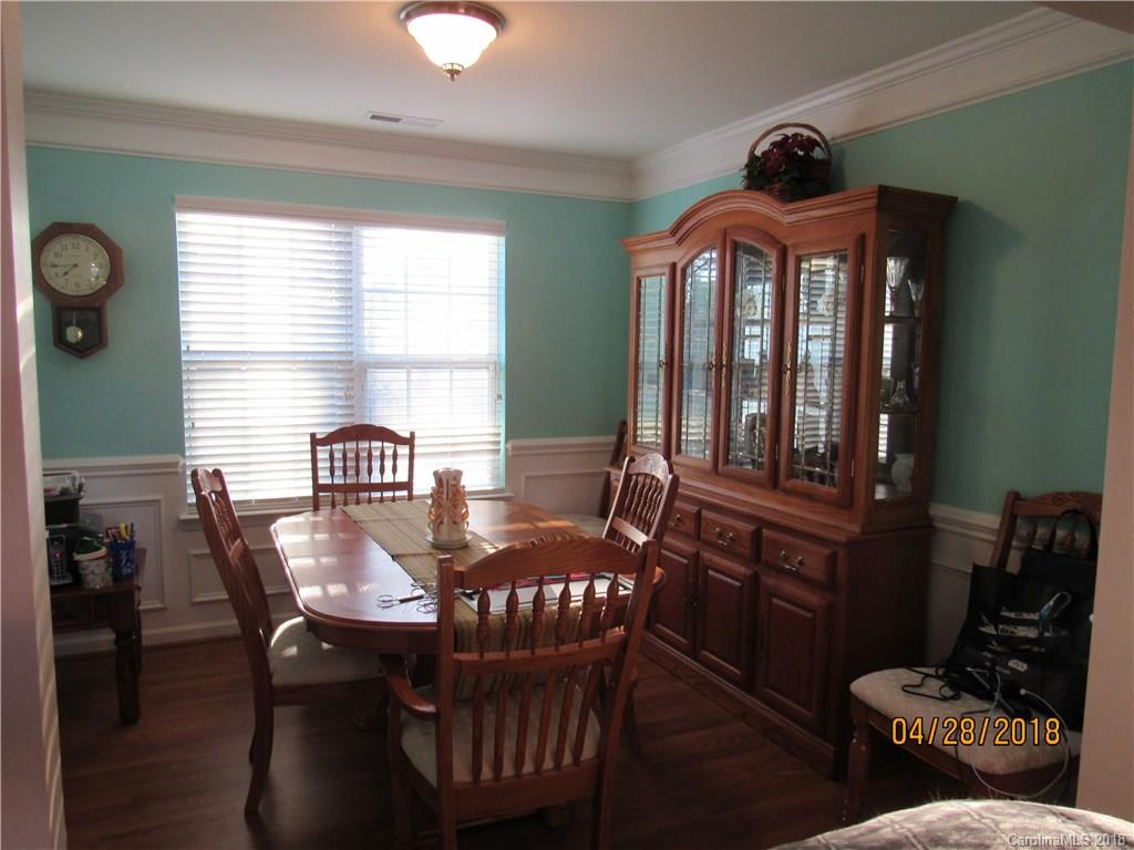 7606 West Berkeley Road Denver, NC 28037 - Photo 8 of 22 a view of a dining room with furniture window and wooden floor