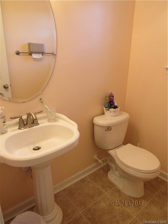 7606 West Berkeley Road Denver, NC 28037 - Photo 9 of 22 a bathroom with a sink mirror and toilet
