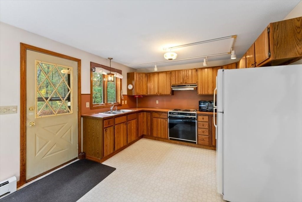 2172 Greenwich Road Hardwick, MA 01082 - Photo 14 of 42 a kitchen with granite countertop a refrigerator and a stove top oven