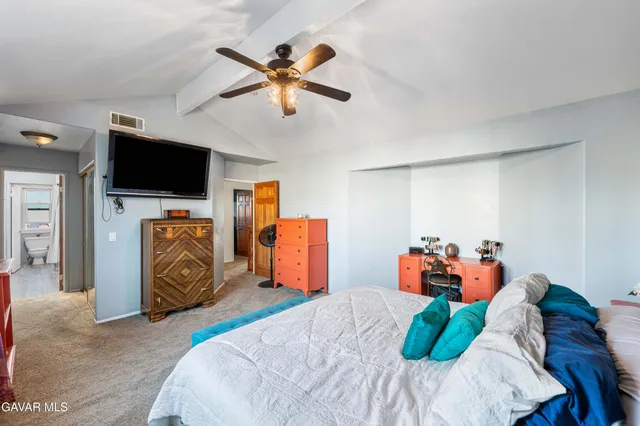 a bed room with a bed and a television