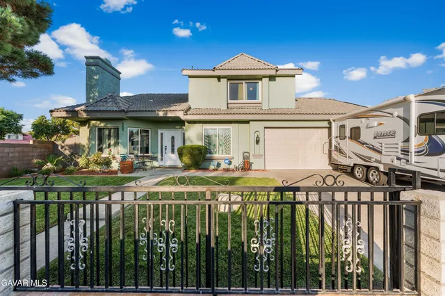 a front view of a house with a yard table and chairs