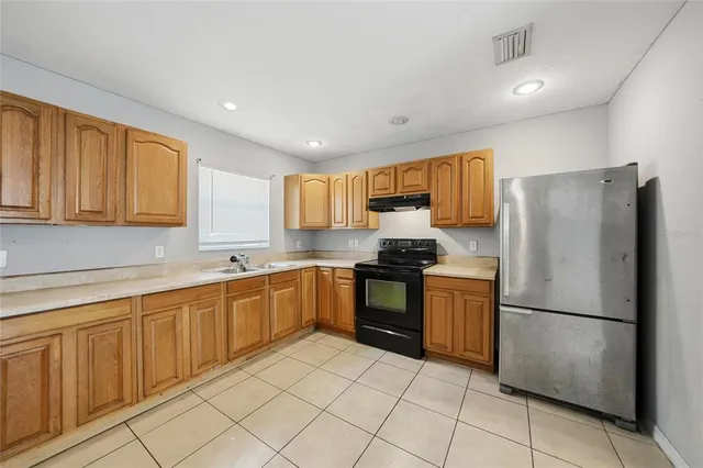 a kitchen with a refrigerator sink and microwave
