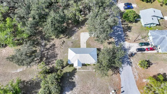 a view of a yard with a wooden fence