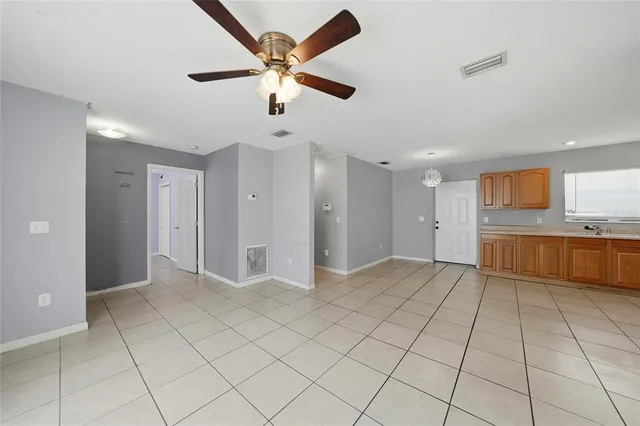 a view of a kitchen with a sink and a refrigerator