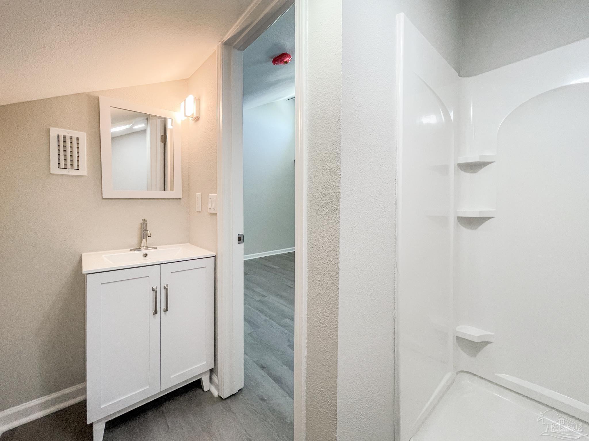 7200 Sharp Reef, Unit 2 Pensacola, FL 32507 - Photo 19 of 24 a bathroom with a sink and a mirror