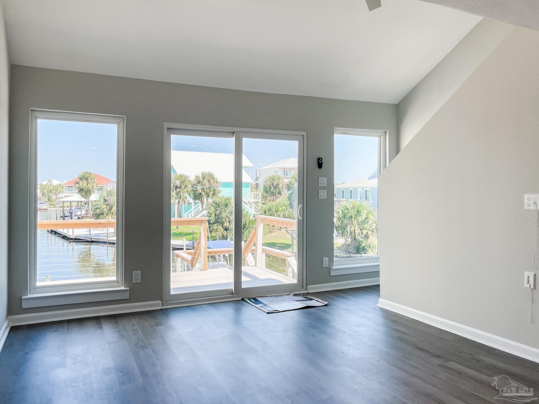 7200 Sharp Reef, Unit 2 Pensacola, FL 32507 - Photo 6 of 24 a view of an empty room with wooden floor and a window