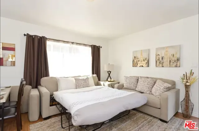 a bedroom with a bed and a couch