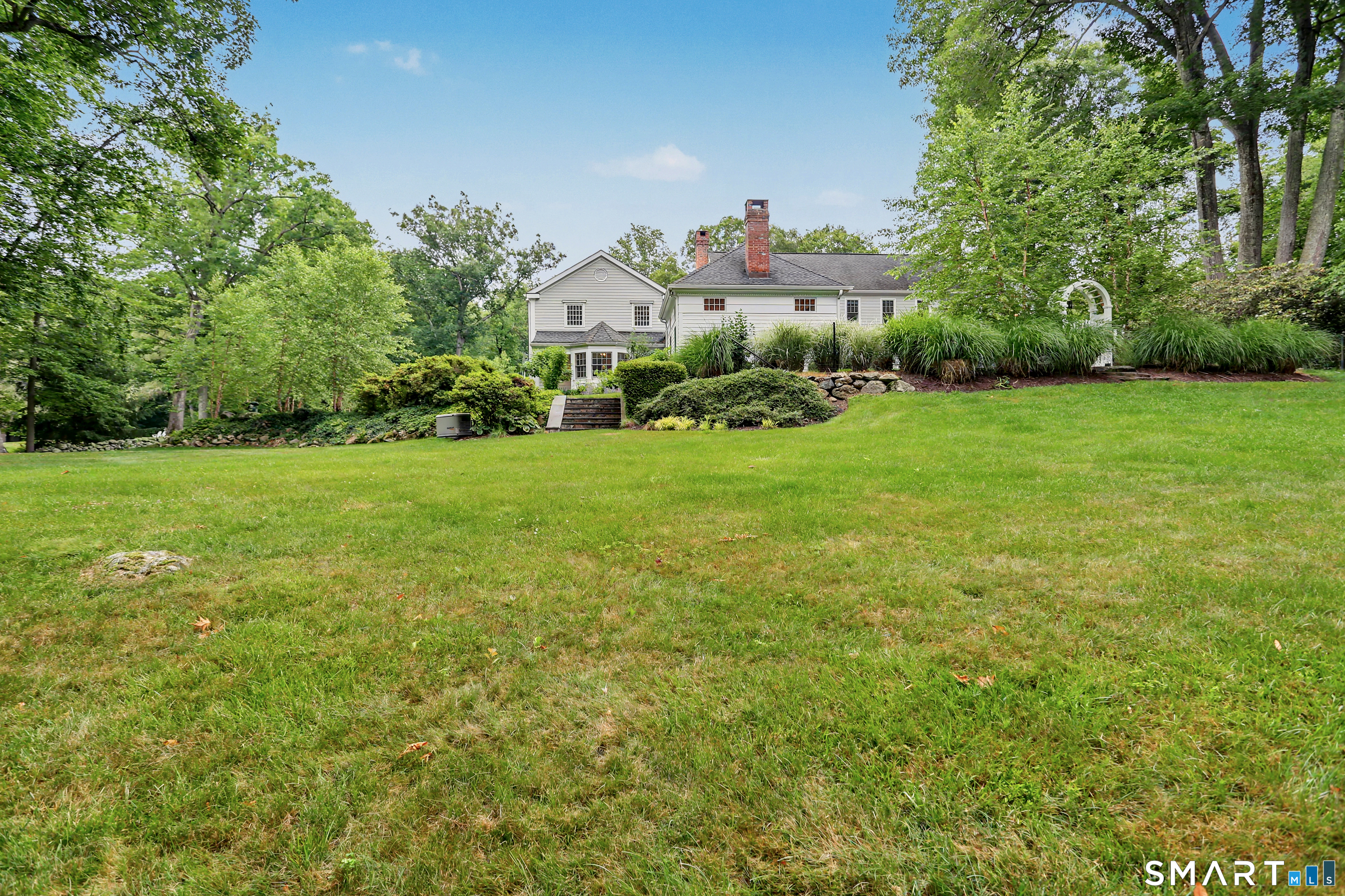 108 Logan Road New Canaan, CT 06840 - Photo 36 of 40 a front view of a house with garden