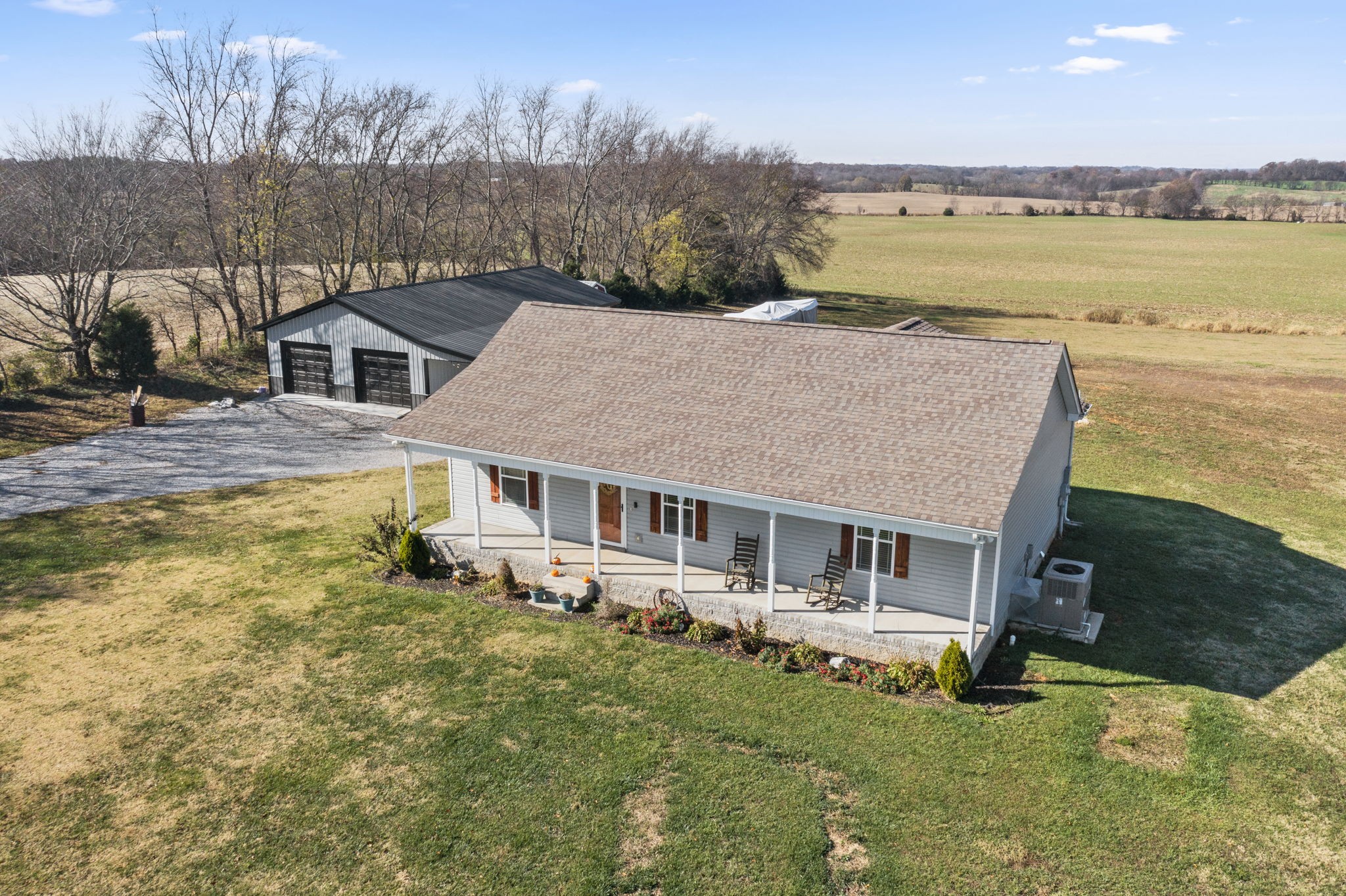 an aerial view of a house with a garden and lake view