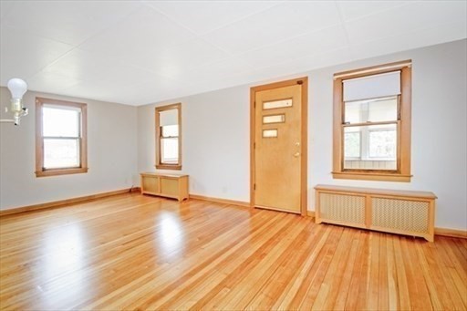 1307 Burnett Road Chicopee, MA 01020 - Photo 11 of 41 a view of an empty room with wooden floor and a window