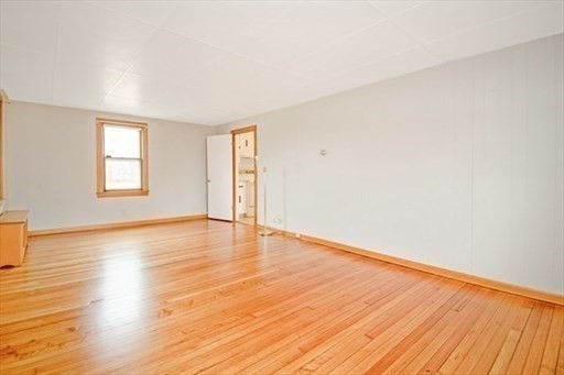 1307 Burnett Road Chicopee, MA 01020 - Photo 12 of 41 an empty room with wooden floor and windows