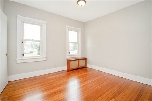 1307 Burnett Road Chicopee, MA 01020 - Photo 13 of 41 an empty room with wooden floor and windows