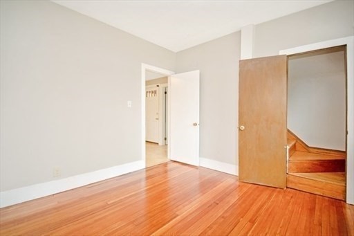 1307 Burnett Road Chicopee, MA 01020 - Photo 14 of 41 a view of an empty room with wooden floor and a window