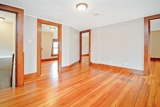 1307 Burnett Road Chicopee, MA 01020 - Photo 16 of 41 wooden floor in an empty room with a window