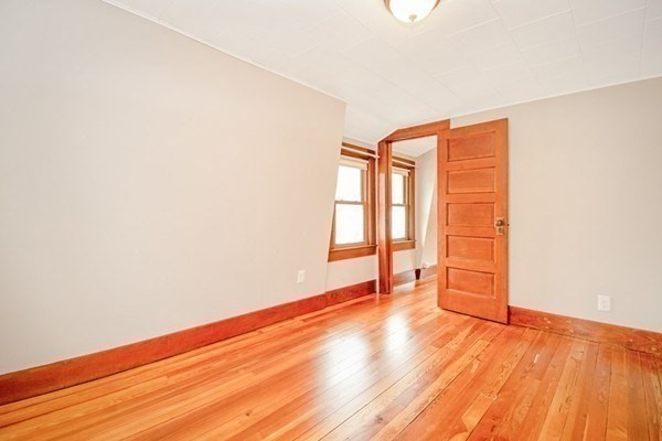 1307 Burnett Road Chicopee, MA 01020 - Photo 17 of 41 an empty room with wooden floor and windows