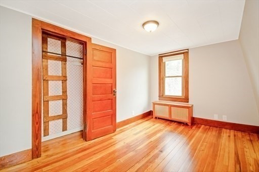 1307 Burnett Road Chicopee, MA 01020 - Photo 19 of 41 an empty room with wooden floor and windows