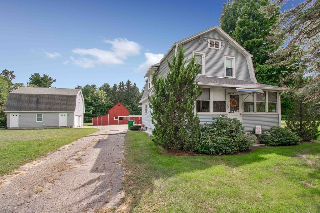 1307 Burnett Road Chicopee, MA 01020 - Photo 2 of 41 a front view of a house with a yard and trees