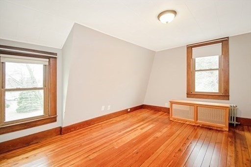 1307 Burnett Road Chicopee, MA 01020 - Photo 22 of 41 an empty room with wooden floor and windows