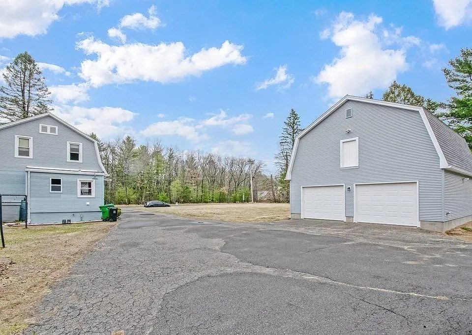 1307 Burnett Road Chicopee, MA 01020 - Photo 3 of 41 a front view of a house with a yard and garage