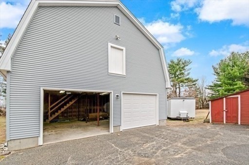 1307 Burnett Road Chicopee, MA 01020 - Photo 32 of 41 a view of a house with a yard and garage