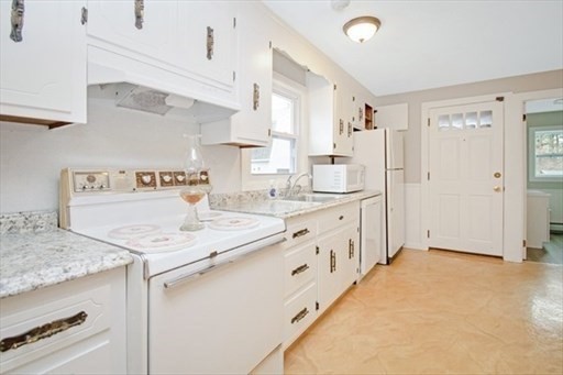 1307 Burnett Road Chicopee, MA 01020 - Photo 4 of 41 a kitchen with granite countertop a sink stove and cabinets