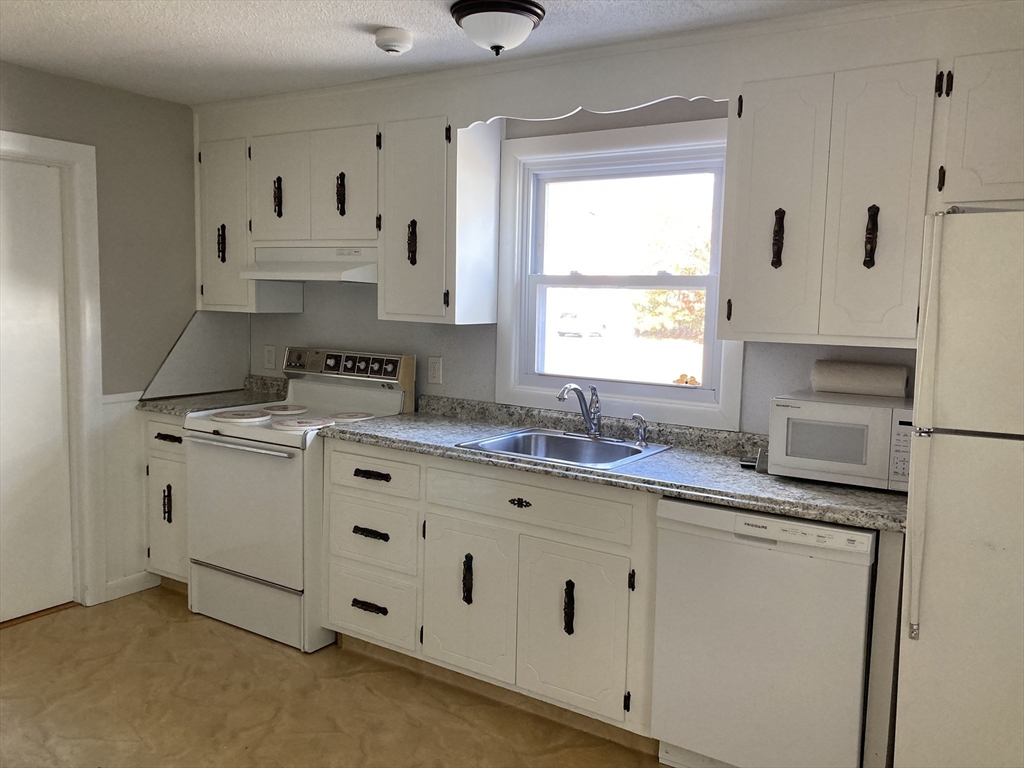 1307 Burnett Road Chicopee, MA 01020 - Photo 6 of 41 a kitchen with cabinets appliances a sink and a window