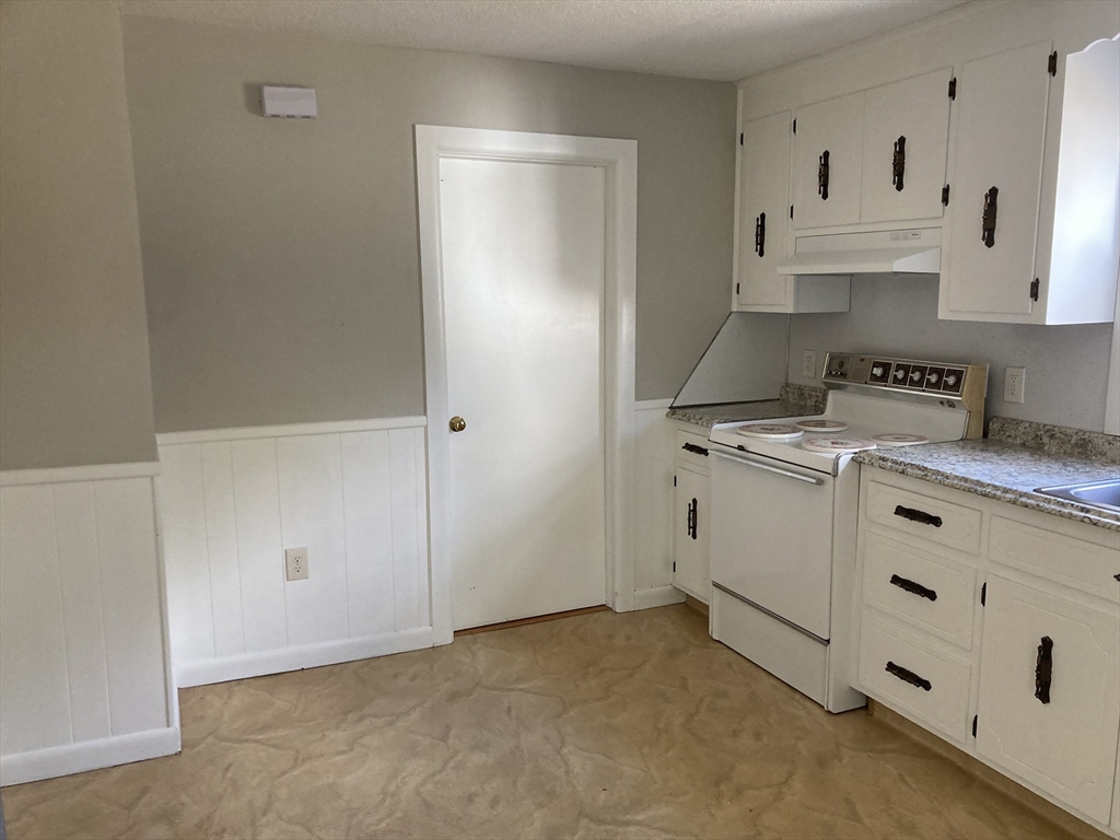 1307 Burnett Road Chicopee, MA 01020 - Photo 7 of 41 a kitchen with cabinets appliances a sink and a counter top space