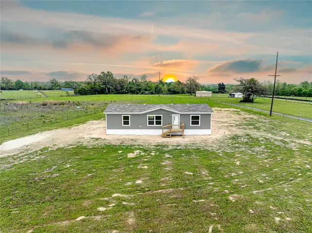 a aerial view of a house with big yard