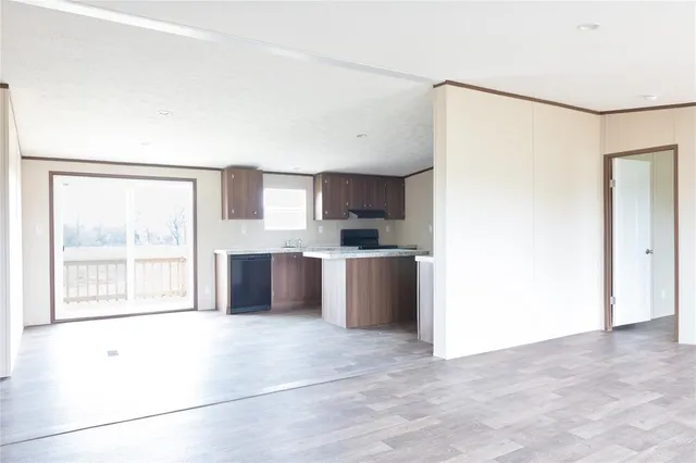 a large white kitchen with granite countertop a refrigerator and a sink