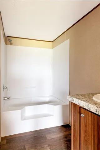 a bathroom with a shower and a bath tub